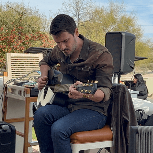 Colin Ager playing guitar at FPAAA's SWIPE